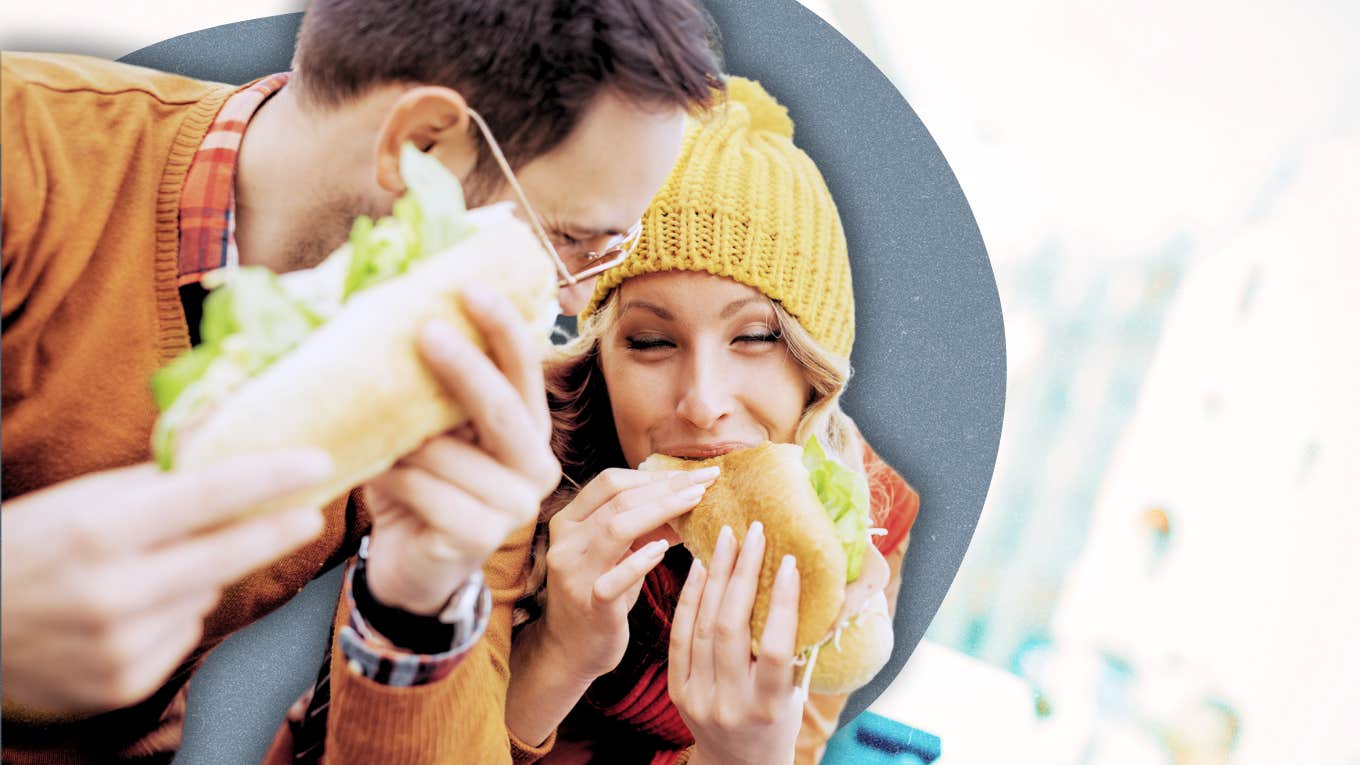 couple spending time together, eating a sandwich 