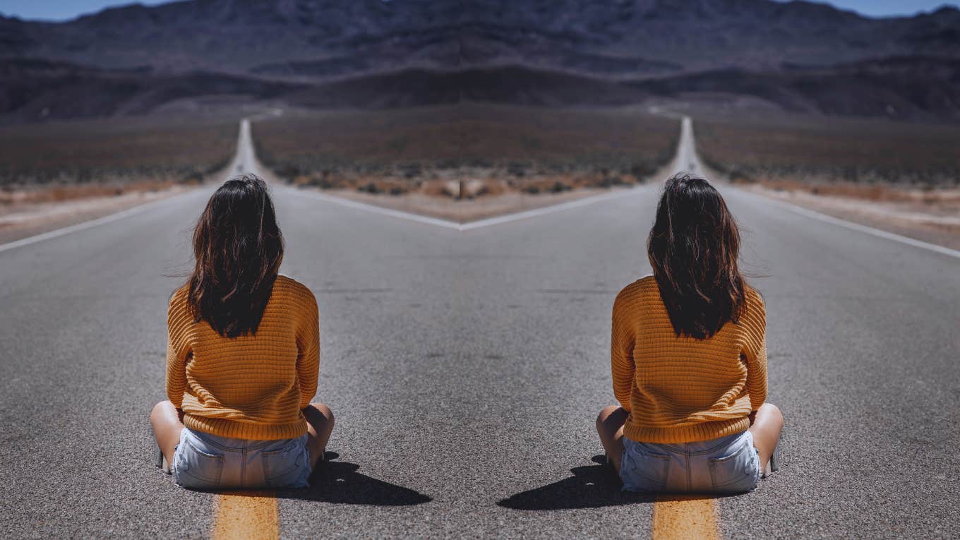 woman sitting on road