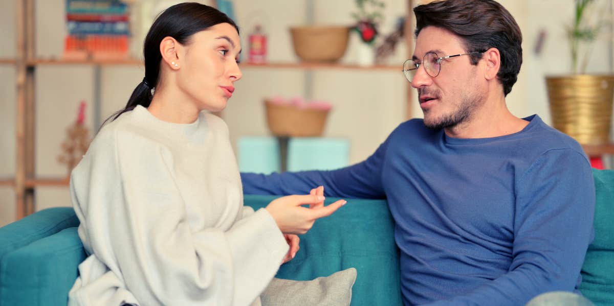 husband and wife talking on the couch