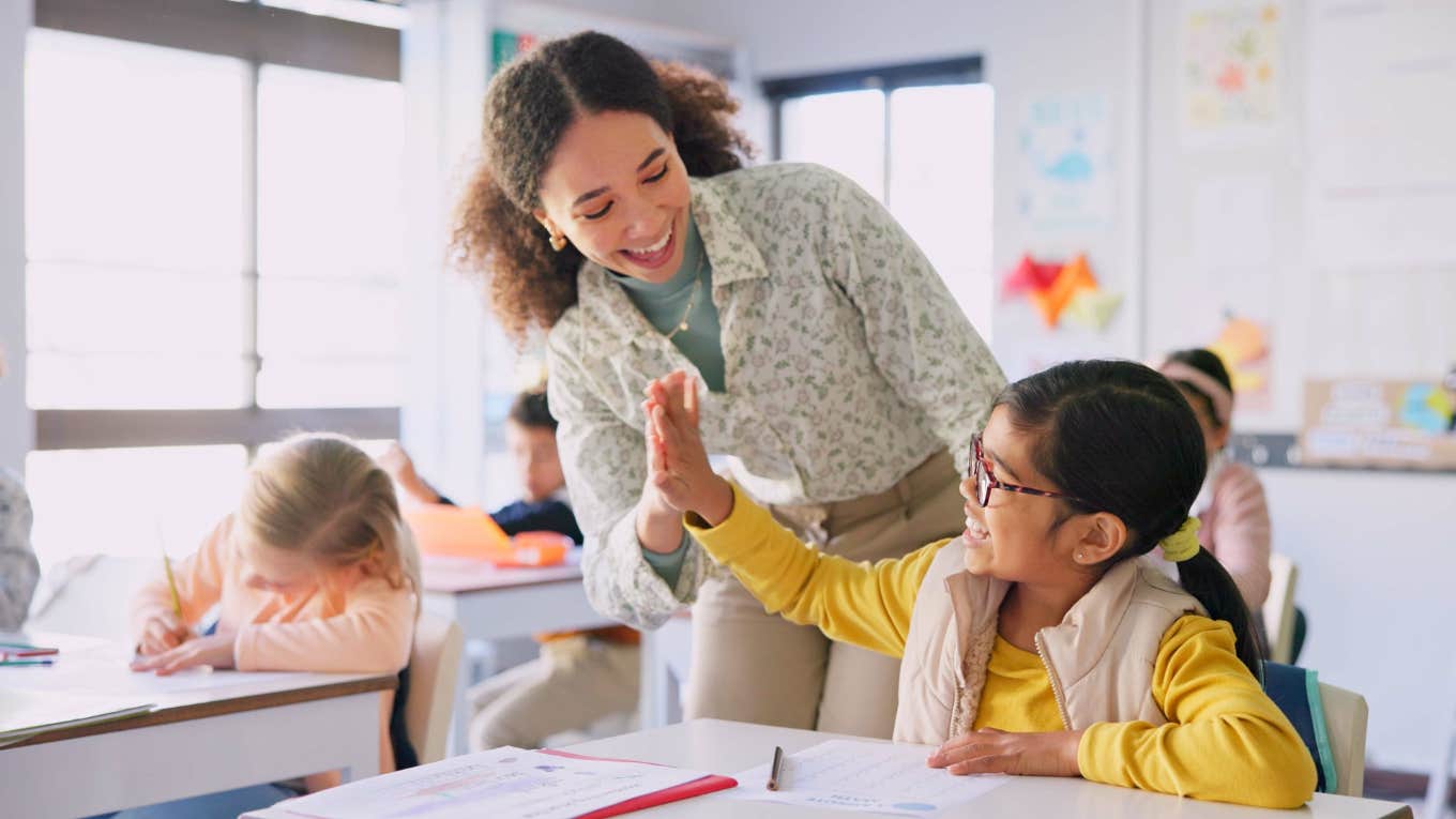 teacher giving student a high five