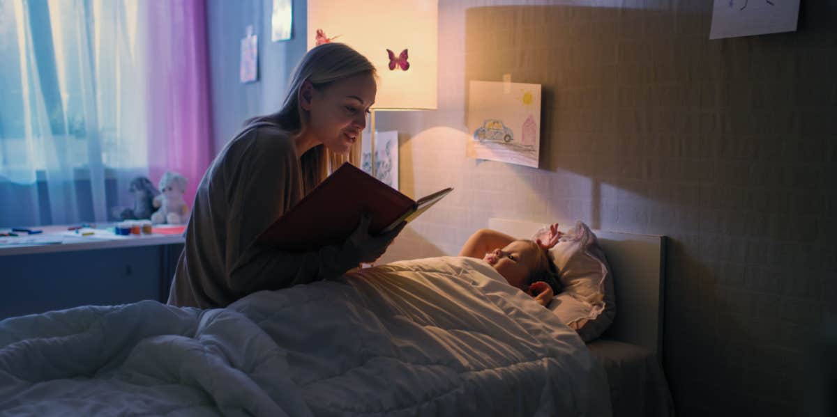 mom reading bedtime story to daughter