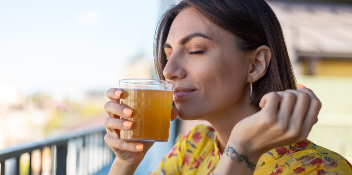 Science Says This Miracle Drink Just Might Be The Ultimate Hangover Cure woman drinking kombucha