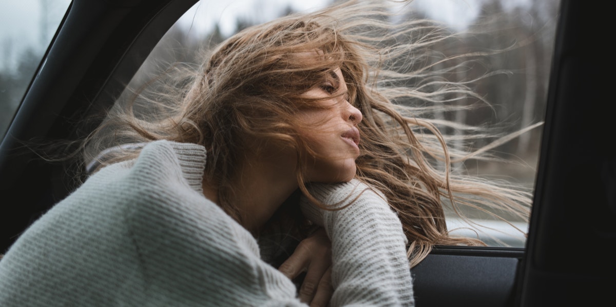 woman looking out car window