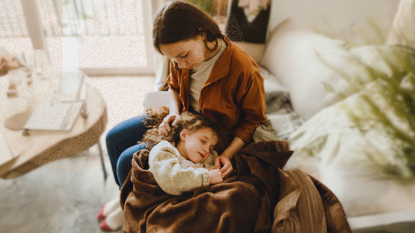 Mother with her daughter laying on her lap