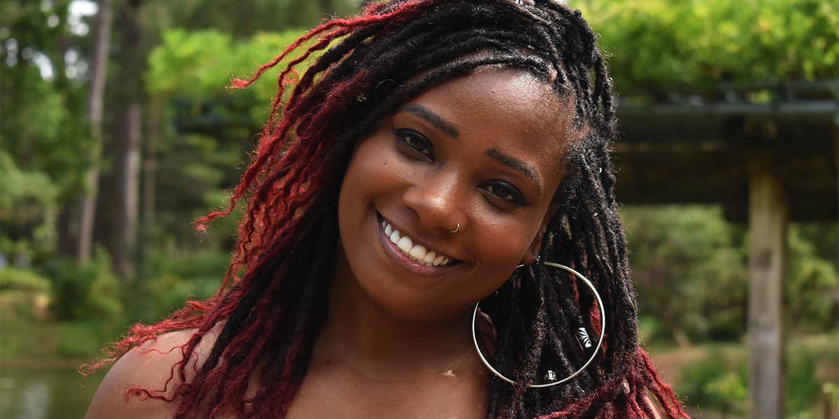 woman smiling wearing hoop earrings