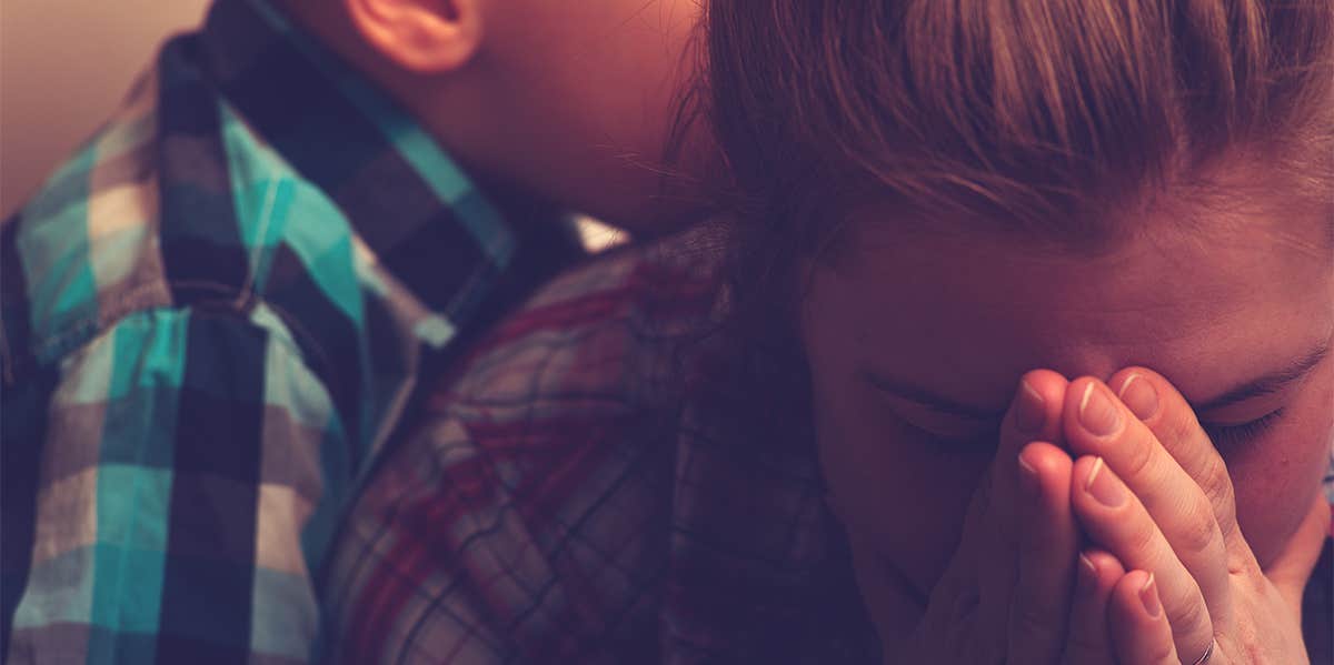 exhausted mother caring for son