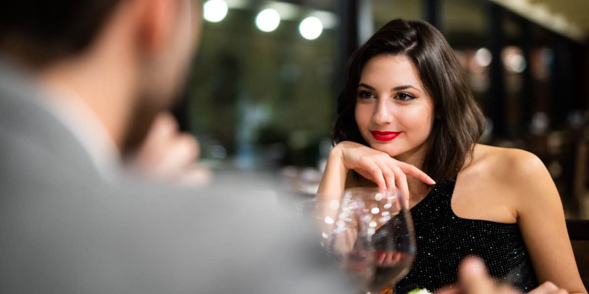 man and woman chatting on dinner date