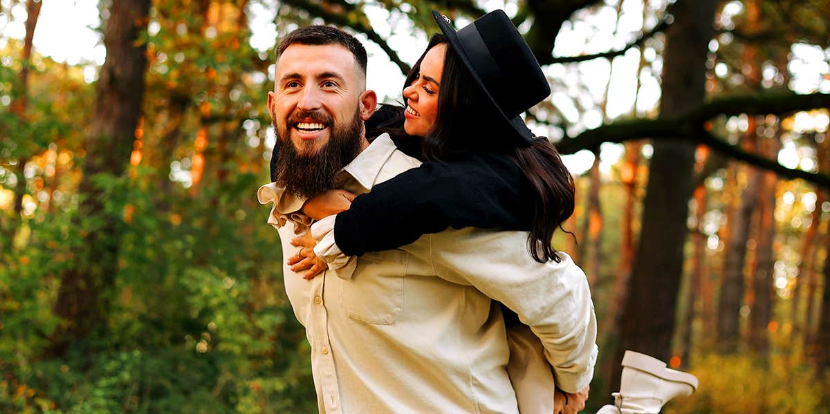 man carrying woman on his back