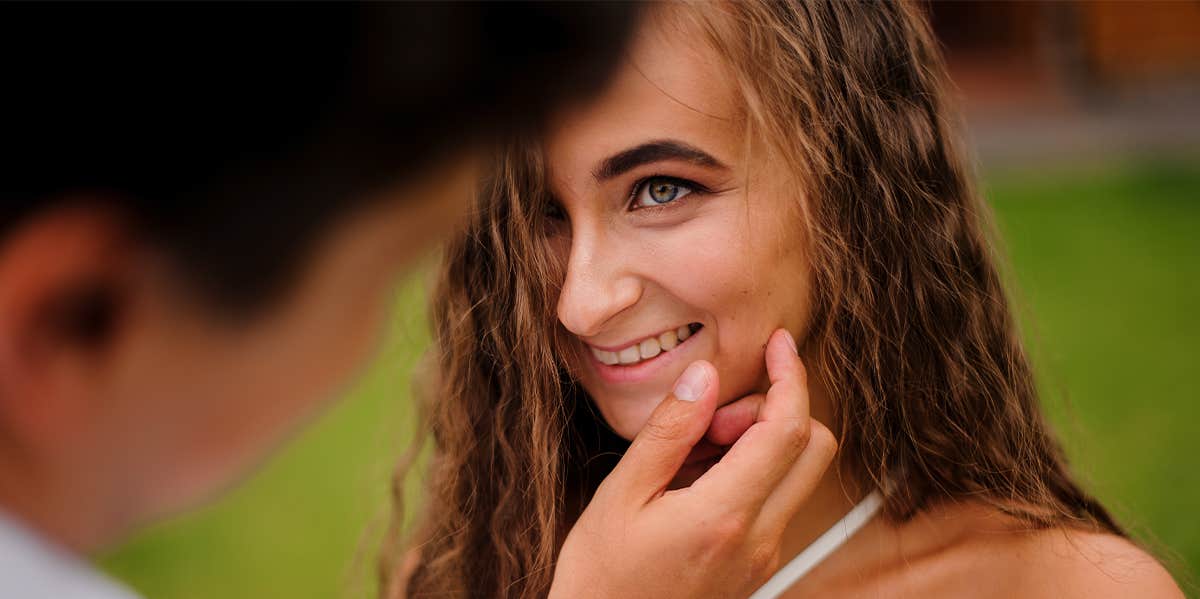 man caressing woman's face