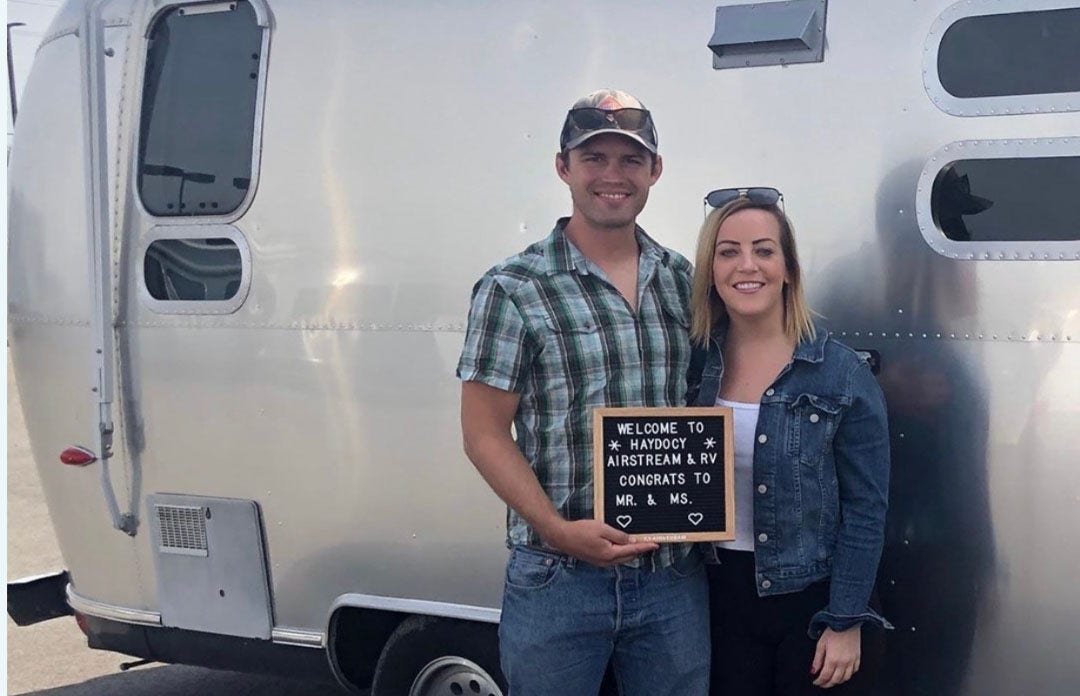 Inspiring photo of Heather and husband Austin captured in front of their Airstream