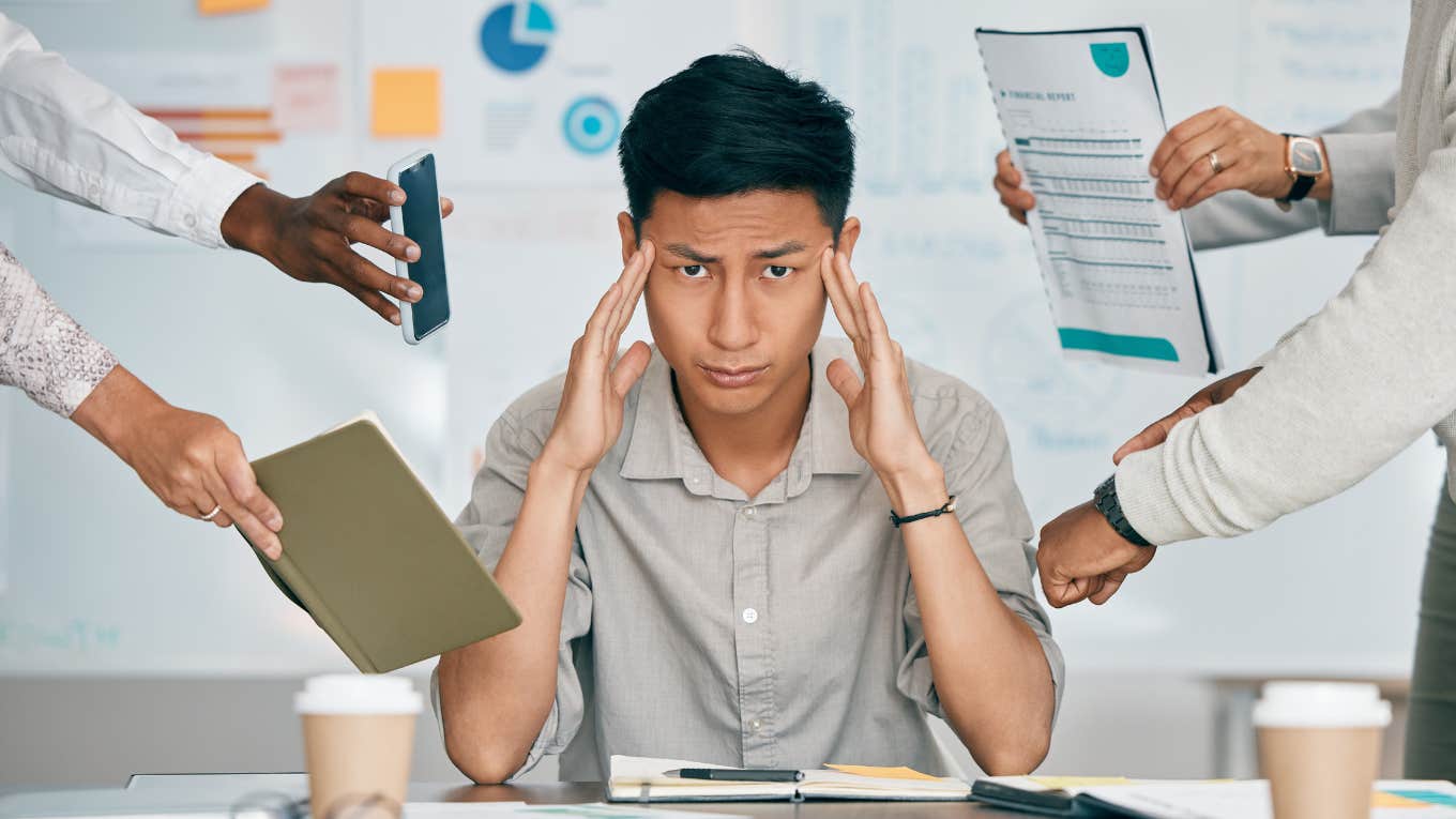 3 Ways Your Boss Will Sabotage You If They're Threatened By You frustrated man at work