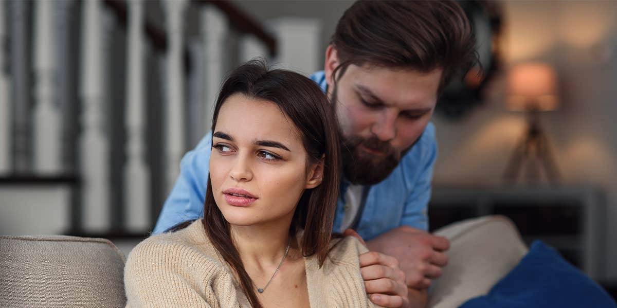 serious woman with man behind her