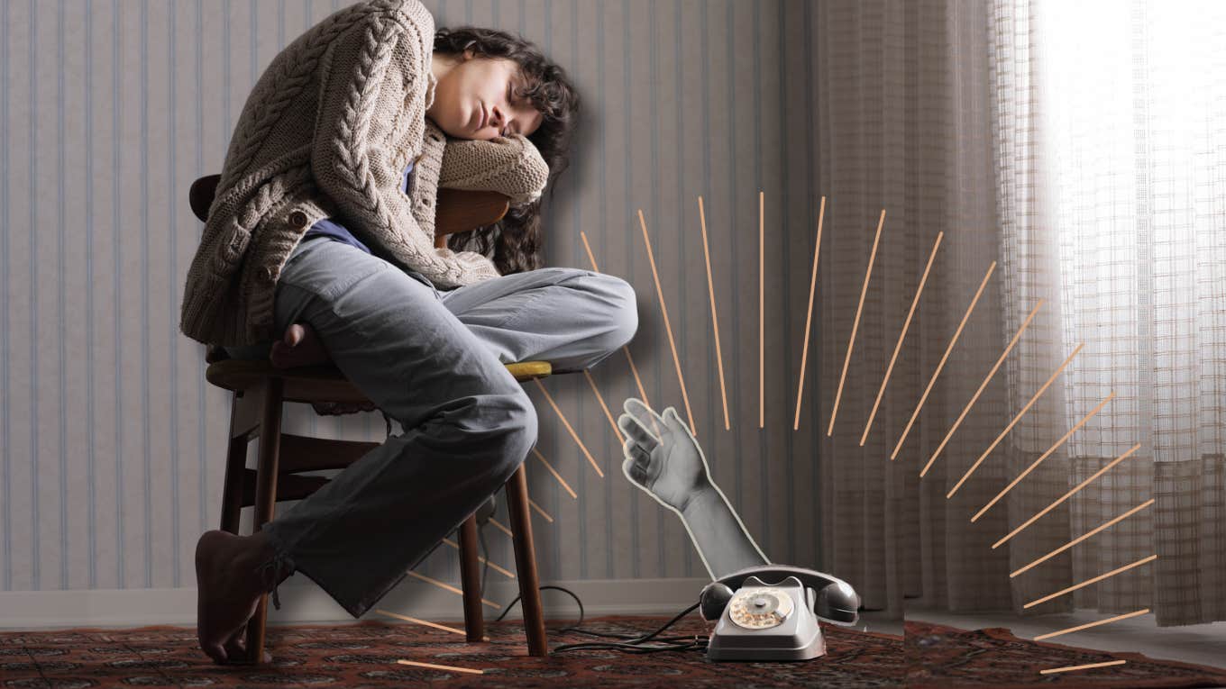 Lonely woman, sitting in chair by phone as it reaches out to her 