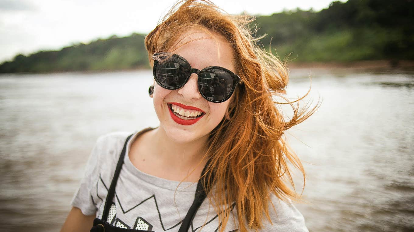 happy woman smiling wearing sunglasses