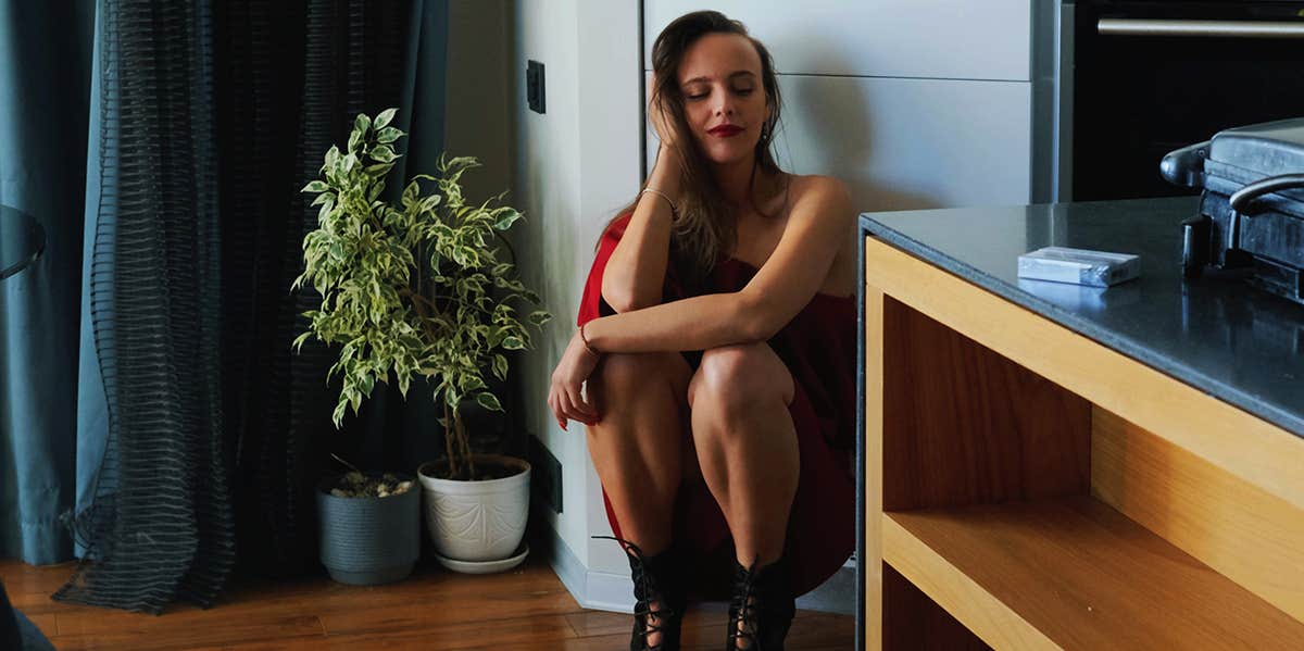 girl kneeling in her apartment 