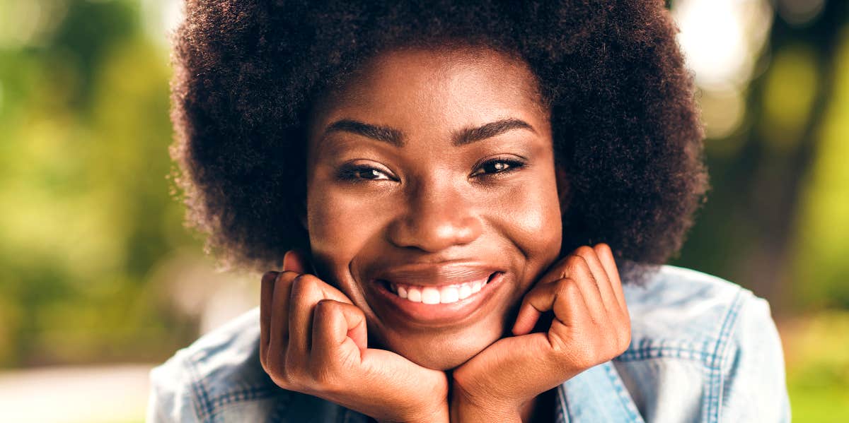 Confident, happy woman smiles toward viewer.