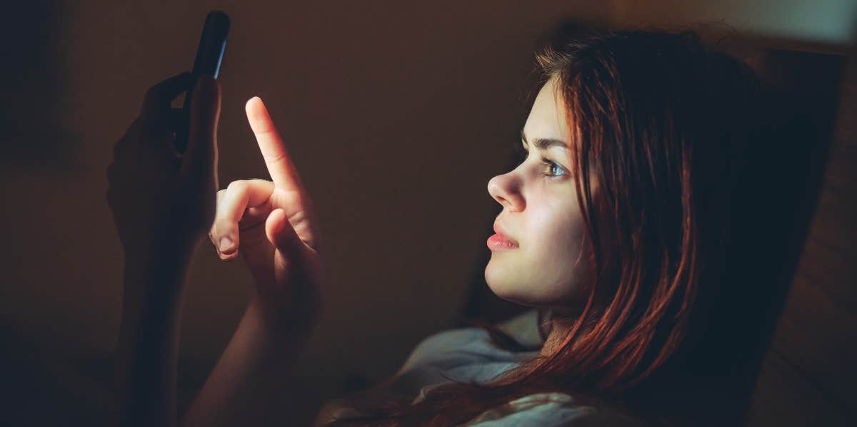 woman scrolling on phone