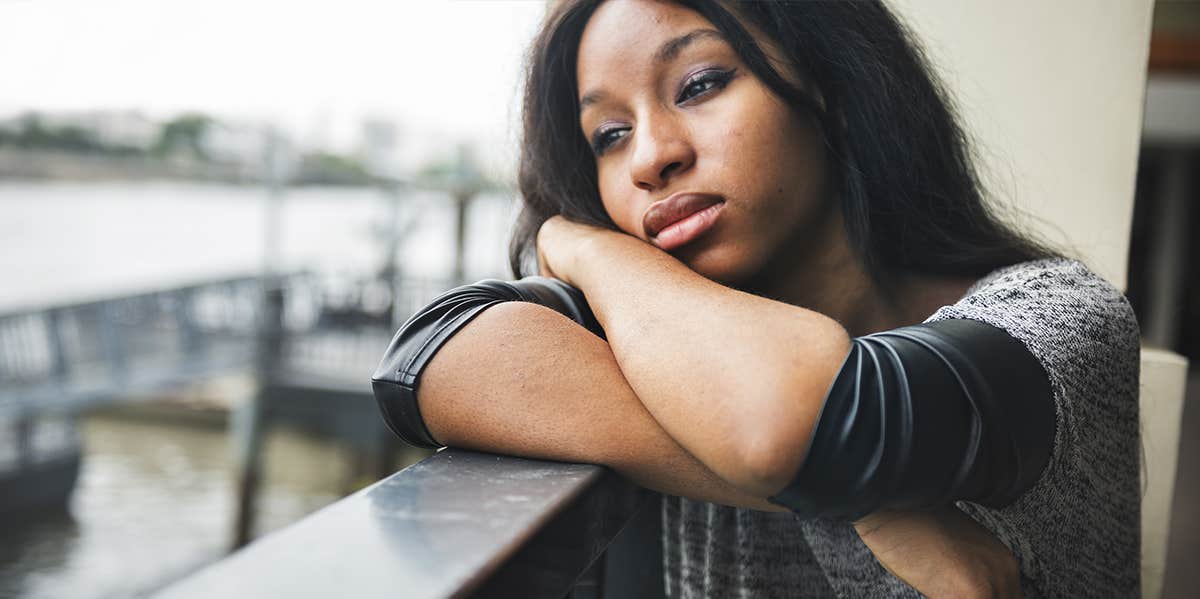 sad woman on window sill