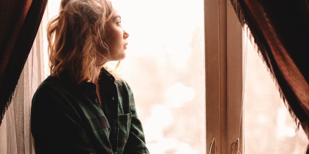 woman looking out window