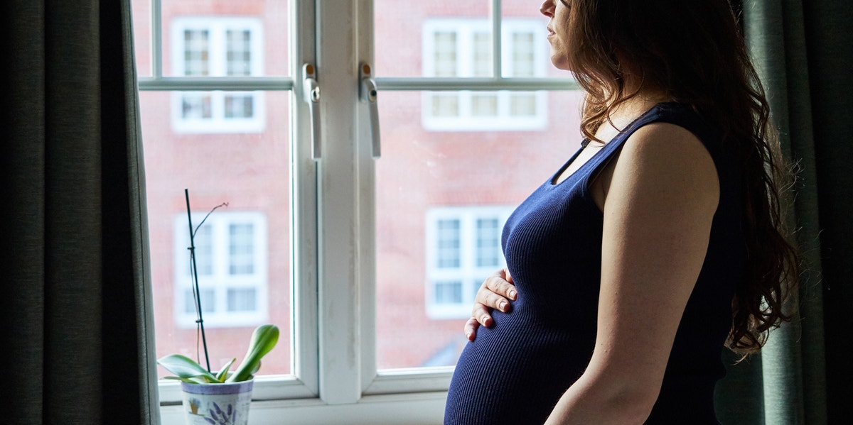 pregnant woman looking out window