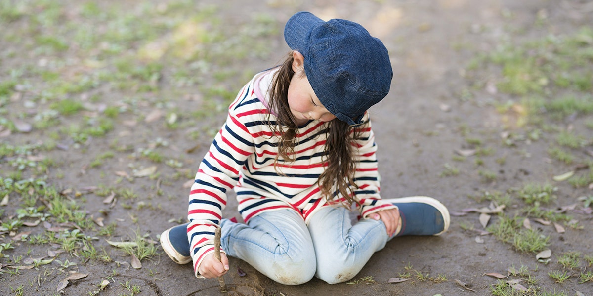 tomboy sitting on grass