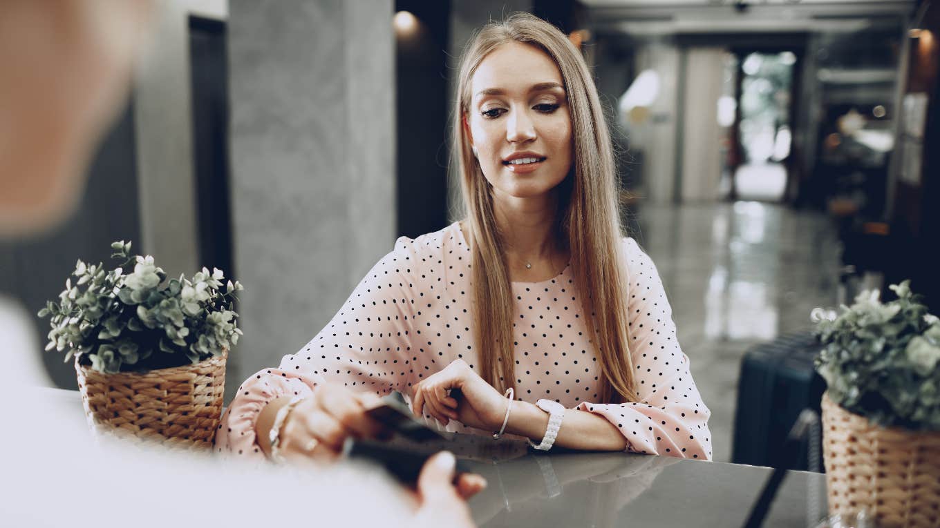 young woman checking into hotel