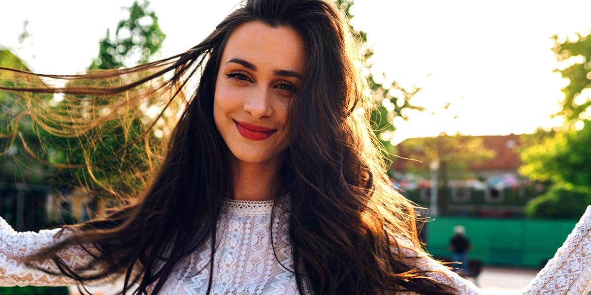 smiling girl playing with her hair