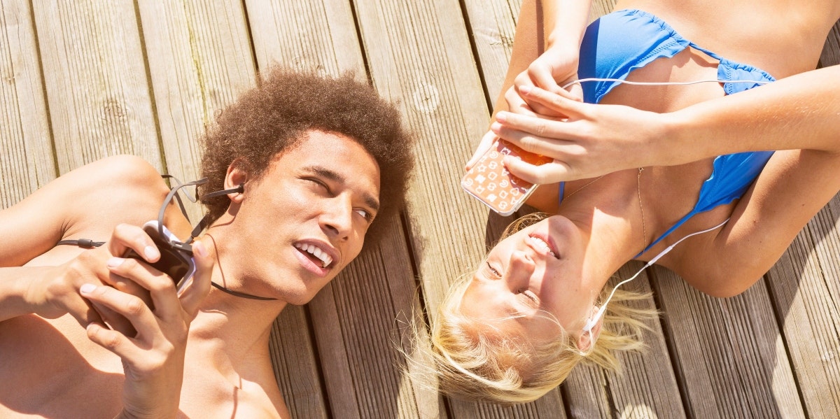 man and woman in swimsuit on smartphones