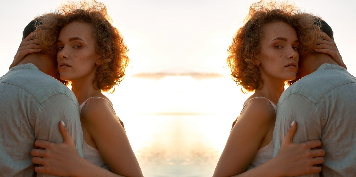 How To Tell The Difference Between A Protective Boyfriend & Toxic Jealousy uncertain woman hugging a man