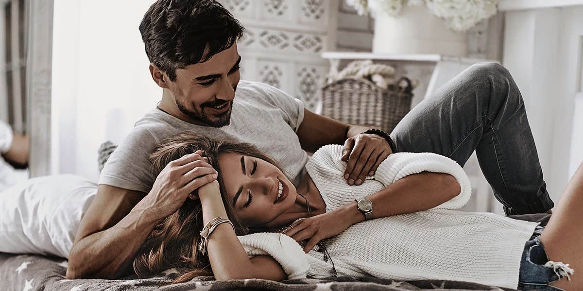 7 Traits Couples With The Strongest Relationships Have In Common happy couple laying down