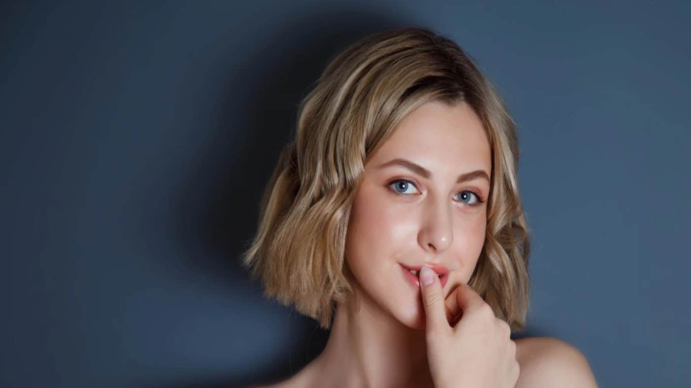 9 Traits Of People Who Have Unusually High Emotional Intelligence woman touching her mouth