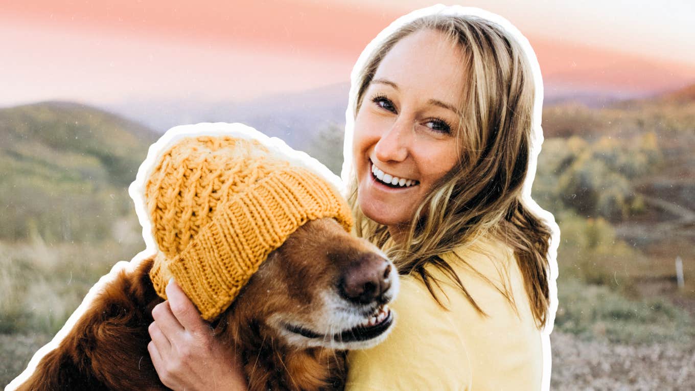 Happy woman loving on her golden retriever 