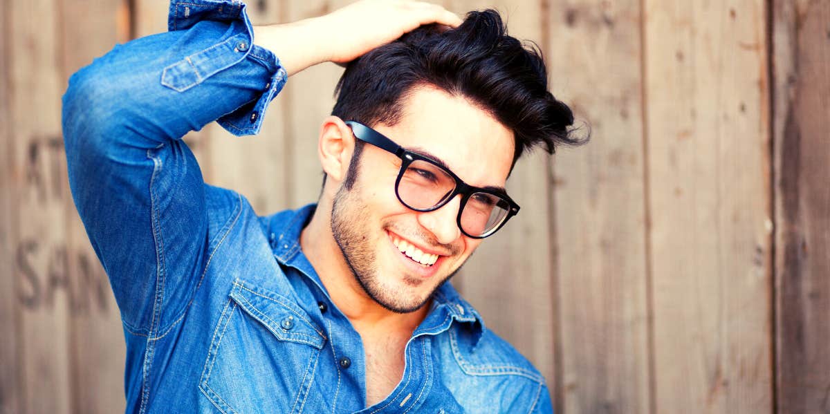 smiling man with traits women find attractive