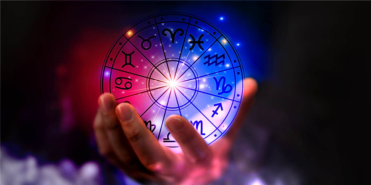 person holding zodiac wheel