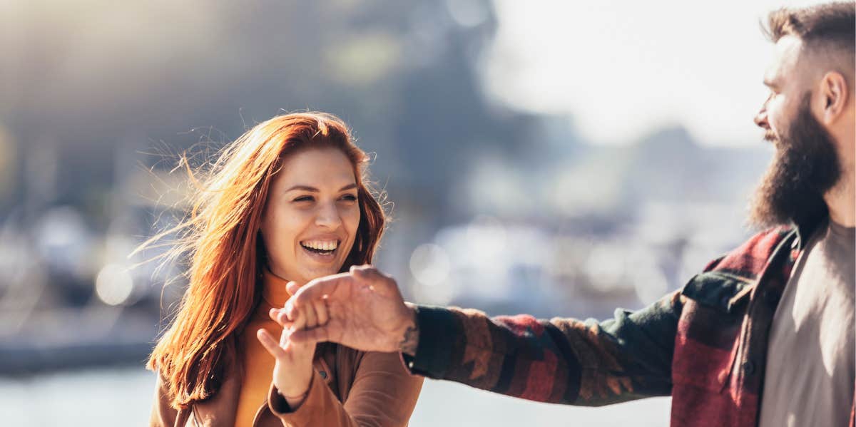 woman holding man's hand