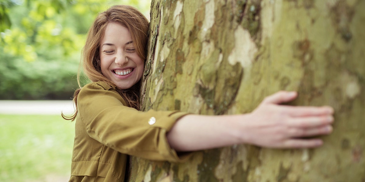 woman hugging tree