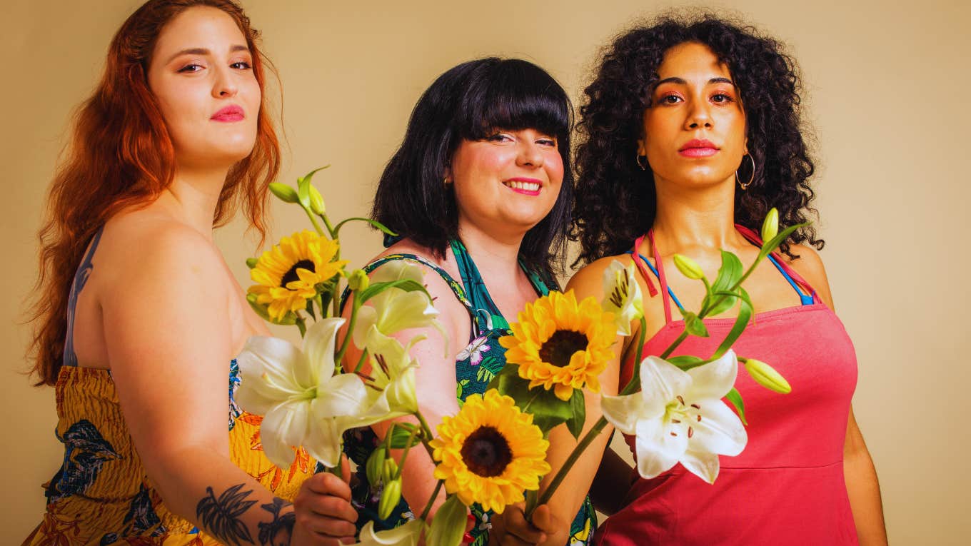 women with body positivity holding flowers