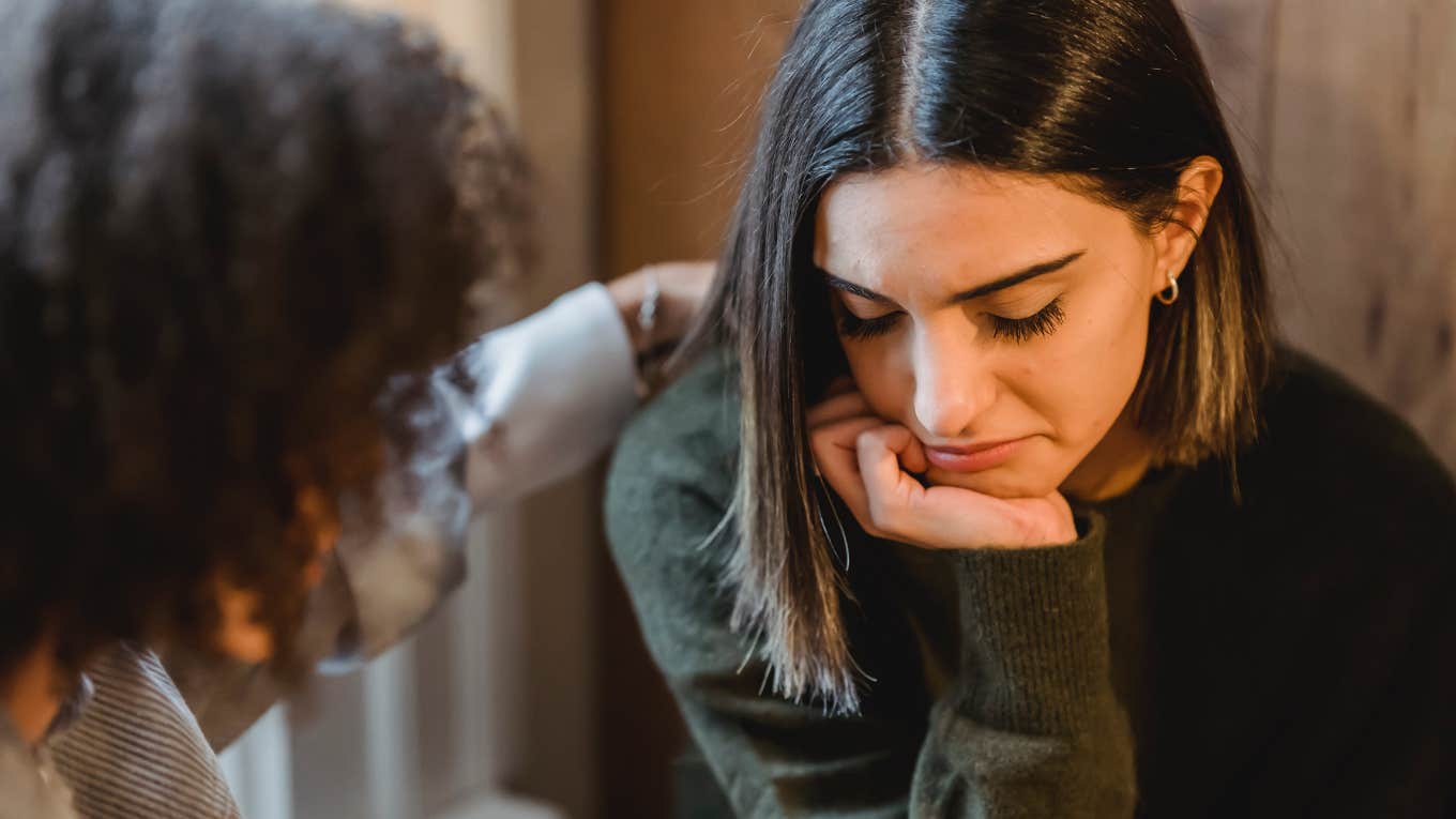 woman comforting another woman 