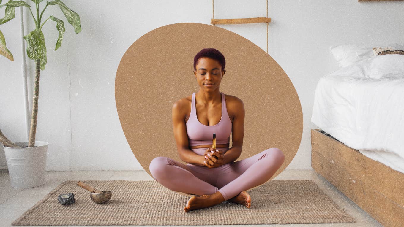 Woman manifesting sitting crossed legged on floor