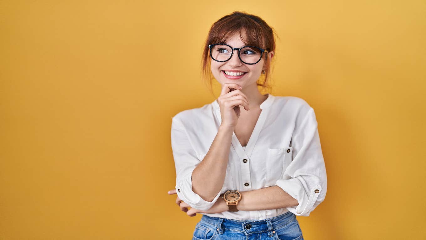 woman with glasses thinking