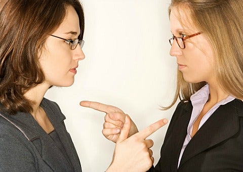 two women pointing at each other