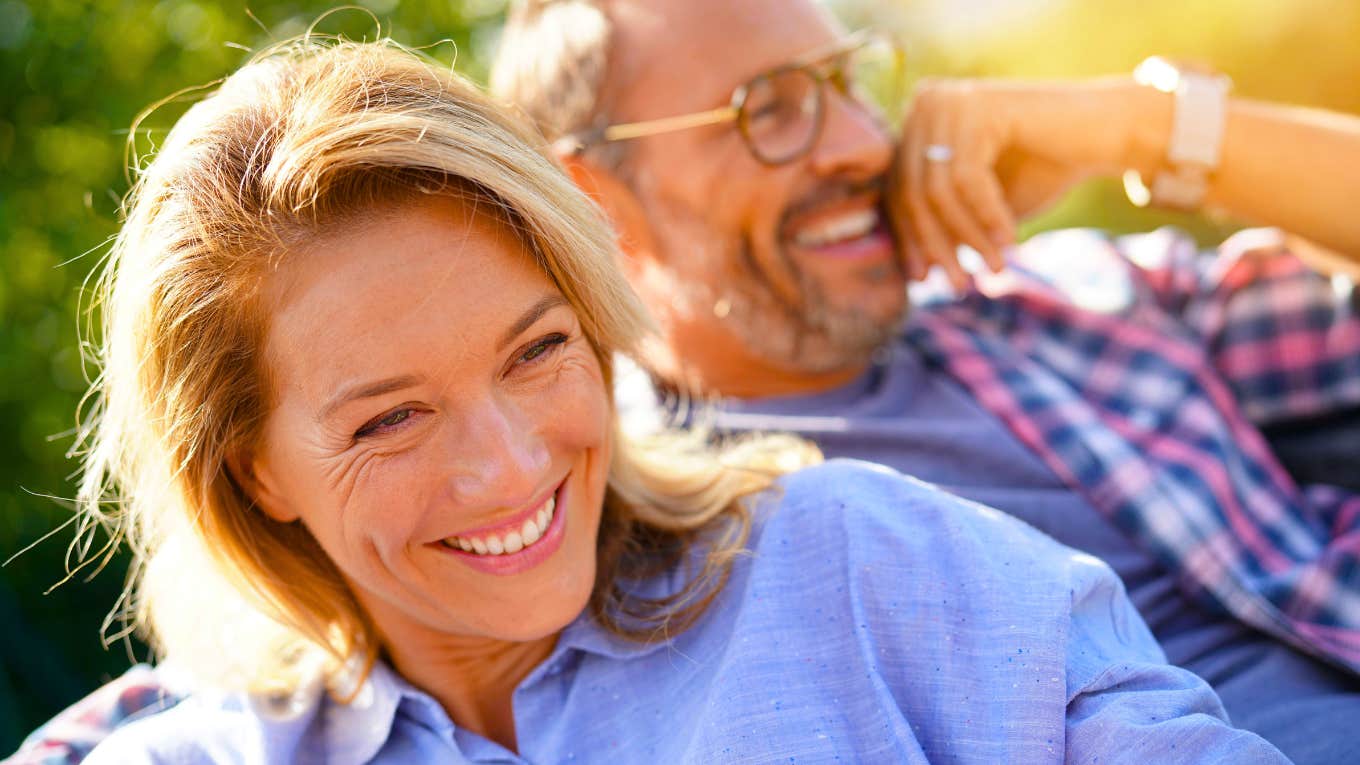 Portrait of mature couple relaxing in outdoor sofa