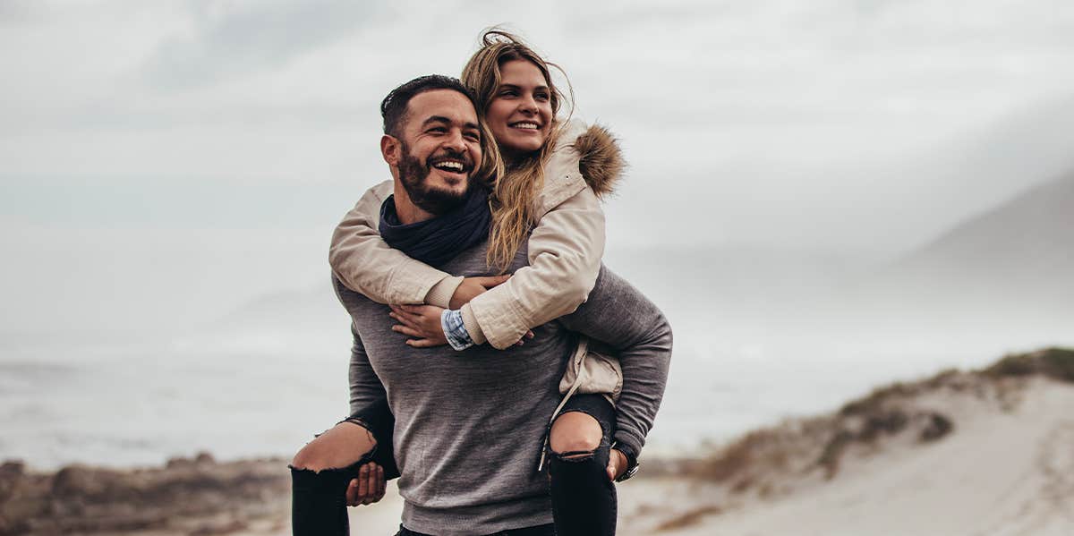 man carrying woman