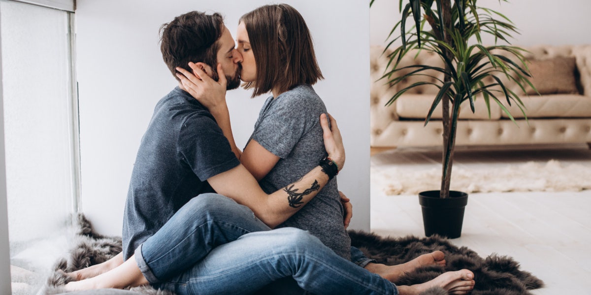 couple kissing passionately on bed