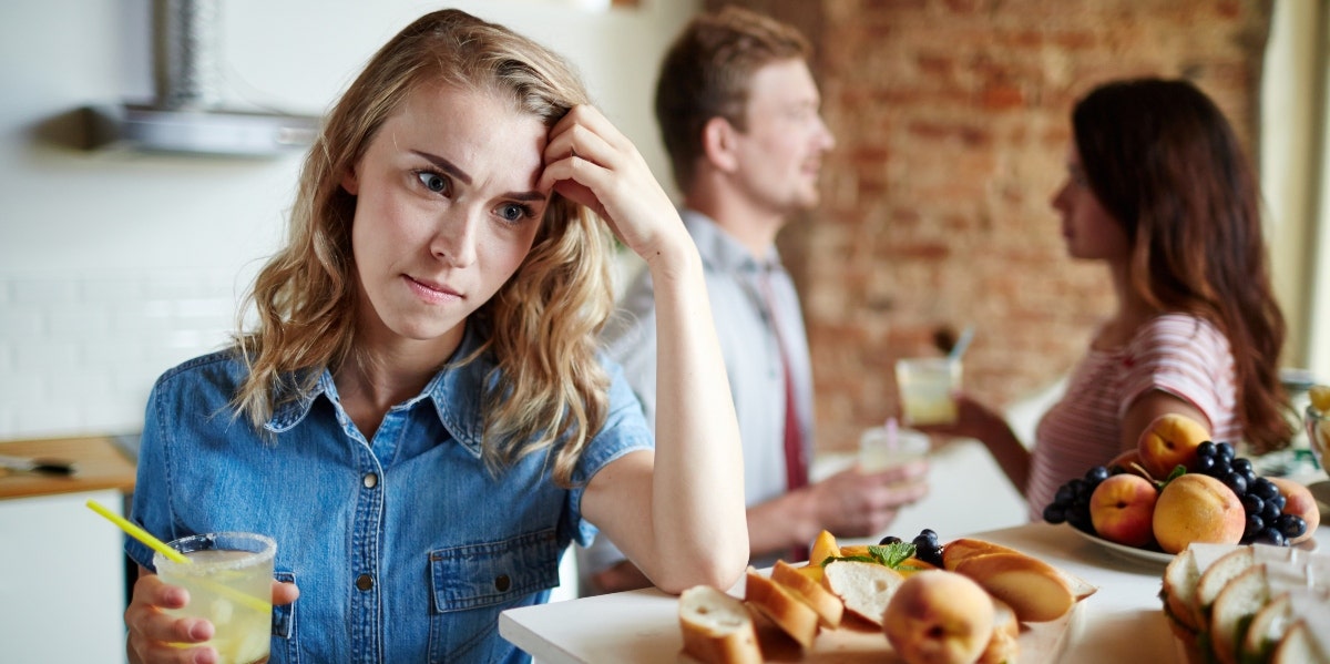 types of cheating woman looking upset while man and woman talk behind her