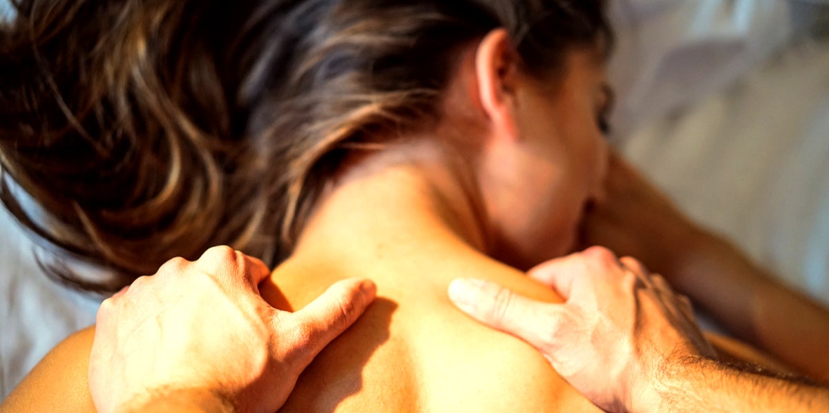 man giving woman sexual massage