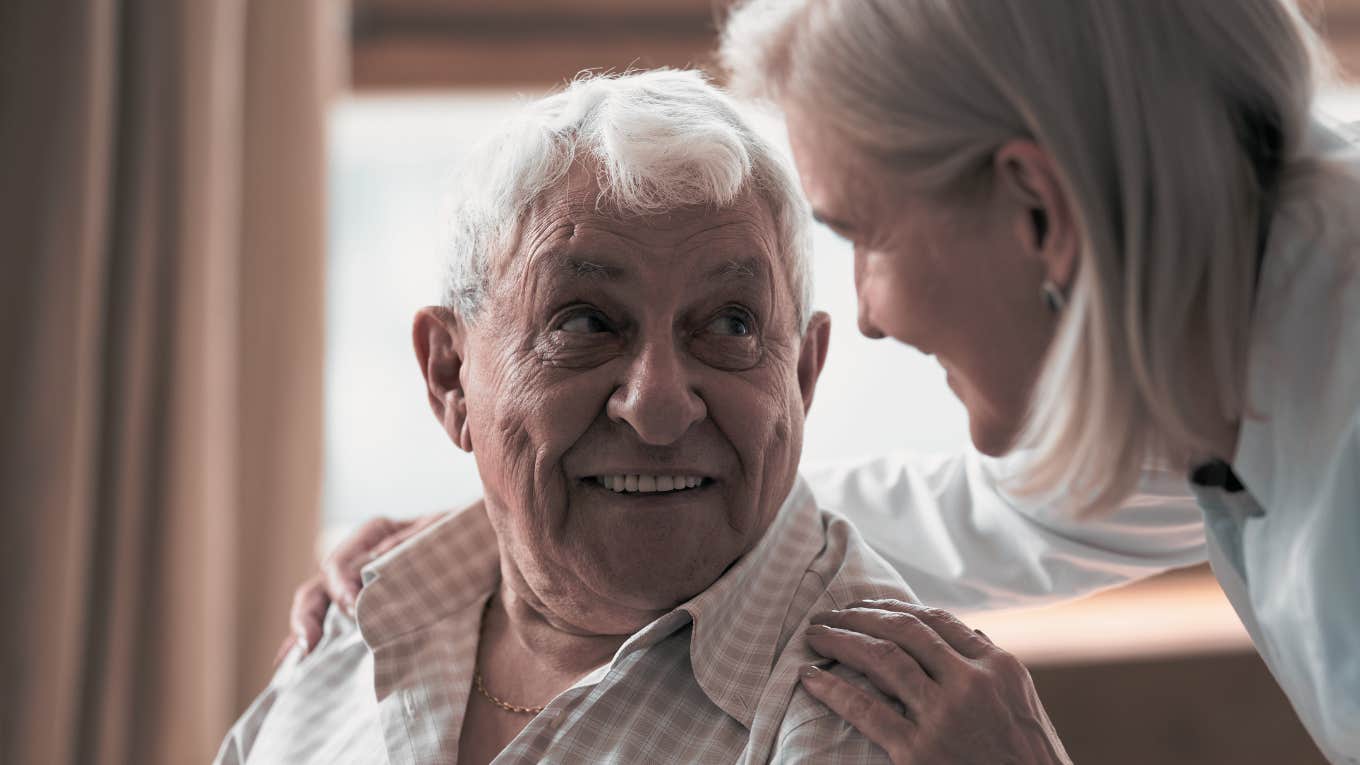 Woman embracing elderly man