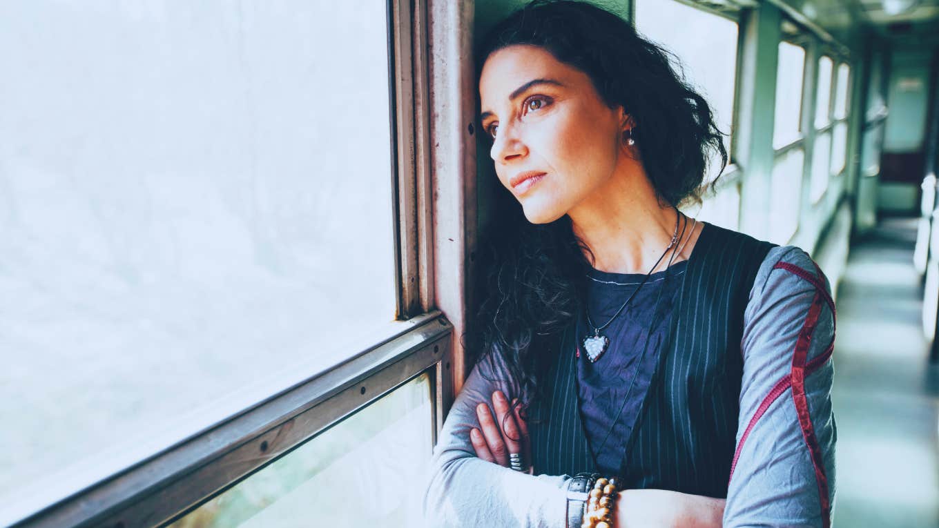 woman looking out a window