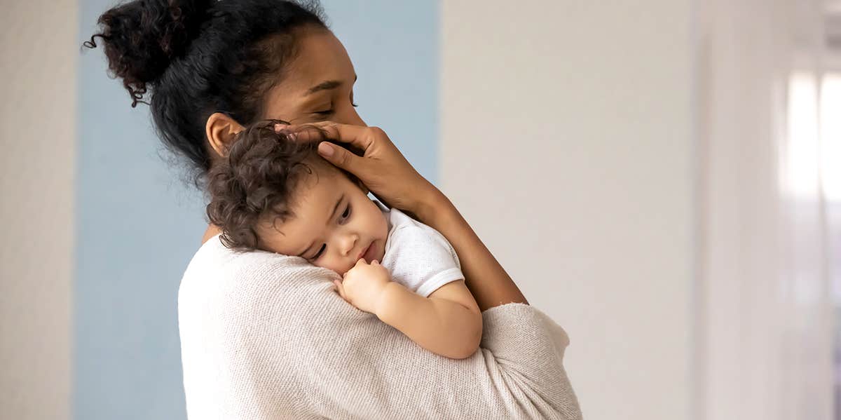 10 Totally Unexpected Things That Happened When I Became A Mom mom holding her baby