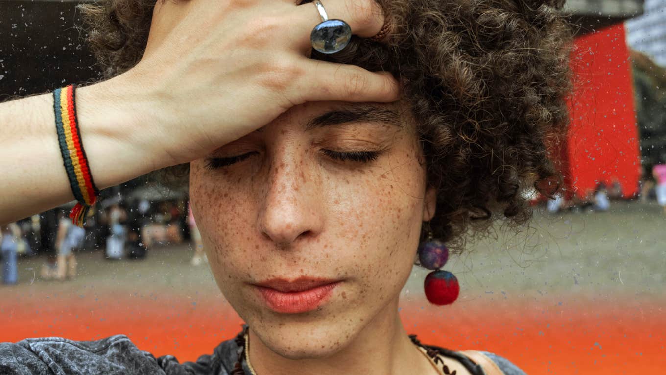 Stressed woman with hand on her forehead